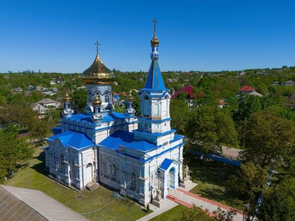 Orthodox church with blue and gold dome under clear sky, aerial view, Biserica de iarna, iarna,
