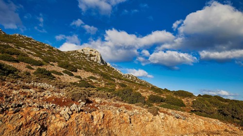 Morning light, mountainous background with vegetation under blue sky with clouds, Rodopou