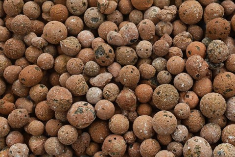 Top view background of brown round expanded clay pellets for keeping house plants in semi