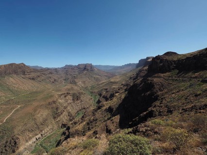 Rocky mountain landscape under clear sky with deep gorge, Barranco de Fataga, Gran Canaria, Spain