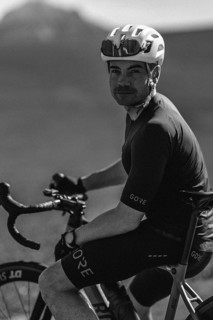 Road bike rider in spring in the Allgäu against the picturesque backdrop of the Alps, Bavaria,