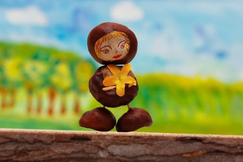 Cute chestnut figure in front of a painted background, North Rhine-Westphalia, Germany