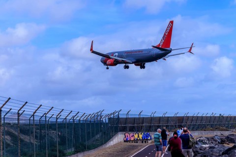 Lanzarote, Canary Islands, Spain, Europe, airport near Arrecife, plane landing over a fenced area,