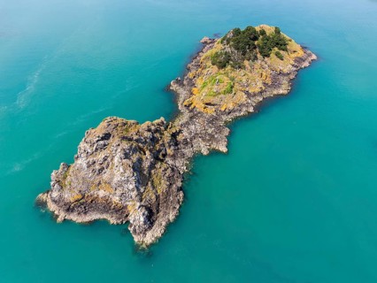 Aerial view of the distinctive rock formation and tidal island of Pointe de la Chaîne on the