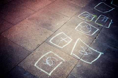 Heaven and hell: boxes with numbers painted by children with chalk on floor plates in Bergedorf,