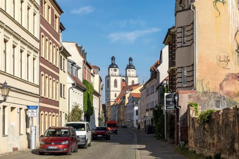 Mittelstraße with towers of the city church, Luther city Wittenberg, Saxony-Anhalt, Germany