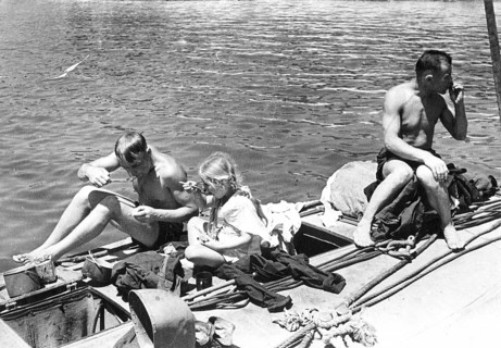 Young girl eating on a warship with soldiers in the first summer after the liberation, Sevastopol,