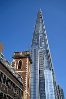 The Shard skyscraper, a historic brick building in the foreground, London Bridge, London, England,