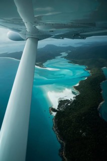 Aerial view of Whitsunday Island beach with airplane propeller and aircraft wing, Airlie Beach,