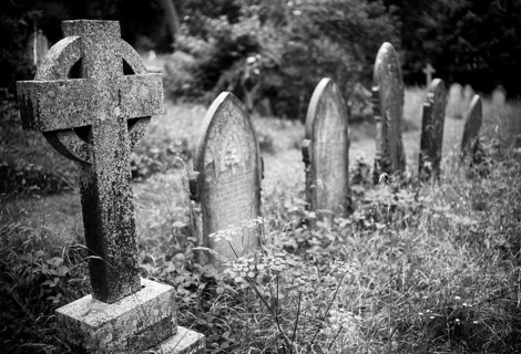 Weathered graves, tombstones, Celtic grave cross, municipal cemetery, Falmouth, Cornwall, black and