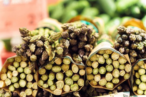 Bunches of green asparagus on the counter at the farmer's market