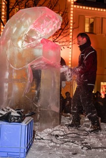 An ice sculpture is being created: ice carving street action as part of the long shopping night in