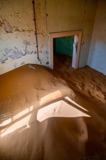 Interior view, doors and house full of sand, former diamond mining town, Namib Desert, Kolmanskop,