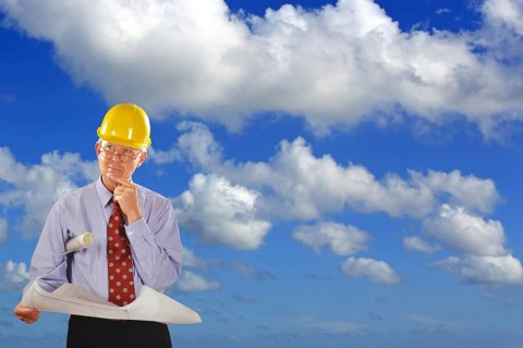 Architect with construction plan and safety helmet visits building projects, renovation, redesign,
