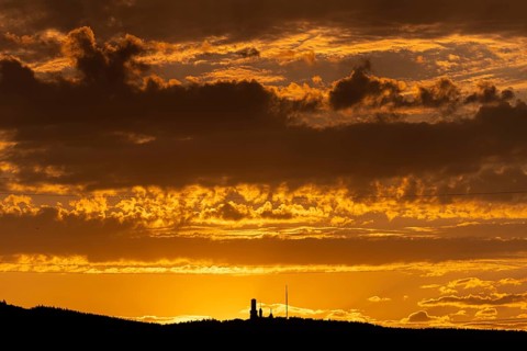 Shortly after sunset, the cloudy sky over the Großer Feldberg in the Taunus Mountains turns yellow
