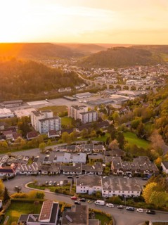 Cityscape at sunset with residential buildings and hilly surroundings, Nagold, district of Calw,