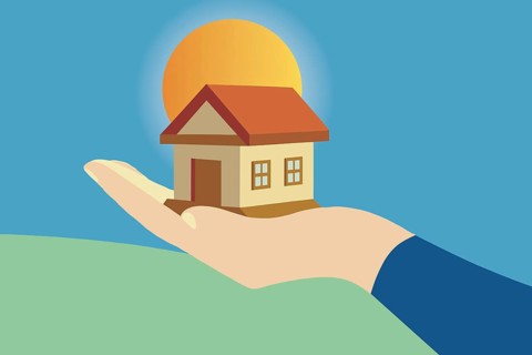 This illustration depicts a small house delicately balanced in an open hand against a vivid sunset