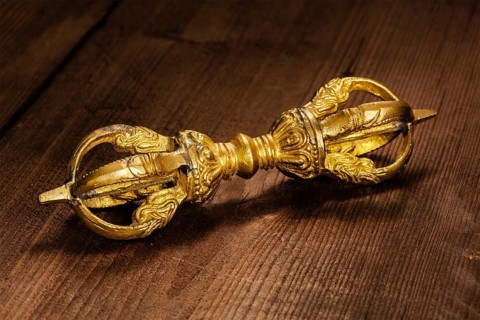 Tibetan Buddhist Dorje vajra ceremonial item on wooden background
