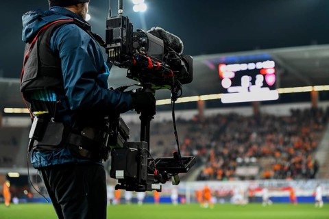 Cameraman behind playing field during soccer match in Lubin, Poland