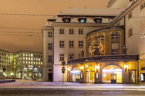 Box office foyer and Christmas tree of the theatre with snow, night shot, Dresden, Saxony, Germany