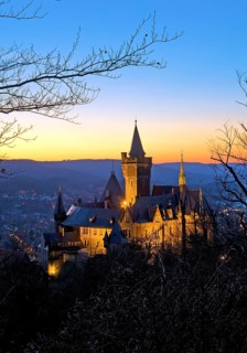 Atmospheric view of the illuminated Wernigerode Castle in the evening, Harz Mountains,