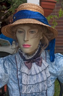 Figure wearing straw hat and nostalgic dress in front of a café, Görllitz, Upper Lusatia, Saxony,