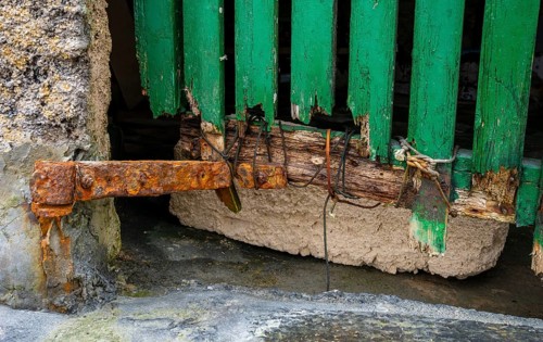 Old and dilapidated boat shelters that are not being used, old port area in Portocolom on the east
