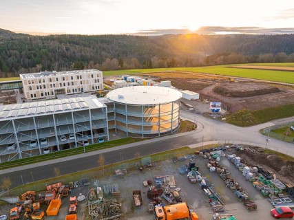 Sunset over an extensive construction site with industrial vehicles, new Calw health campus, Calw