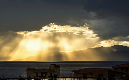 Sun rays in the clouds over Sicily, Tyrrhenian Sea, Italy