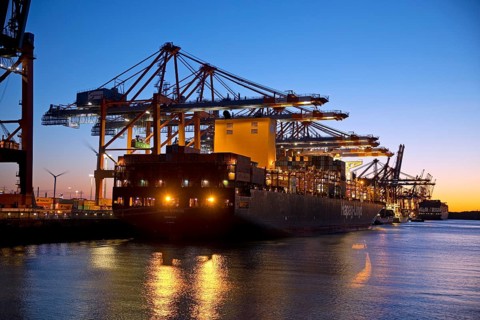 Container ships at the Eurogate container terminal in the evening with an atmospheric sunset,