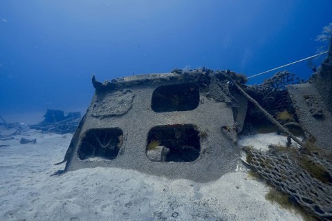 Abandoned shipwreck on the ocean floor surrounded by blue water, meteor wreck dive site, Russian