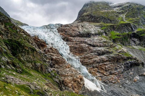 Dramatic mountain landscape covered in clouds with Lower Arctic Sea glacier, Bernese Alps, Bernese