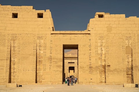 Pylon with reliefs of the mortuary temple of Ramesses III in Medinet Habu, West Thebes near Luxor,