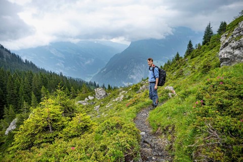 Mountaineers on a hiking trail, cloudy mountains, Bernese Alps, Bernese Oberland, Switzerland