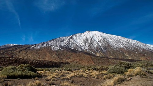 Snowy mountain under clear blue sky, surroundings look barren, Teide, Parque Nacional del Teide,