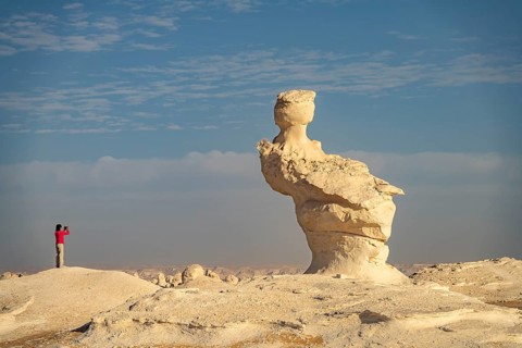 Touris photographs the white limestone formations in the White Desert National Park in the Egyptian