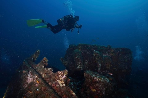 Diver explores colorful shipwrecks on the seabed, Wreck Michel C dive site, Giens Peninsula,