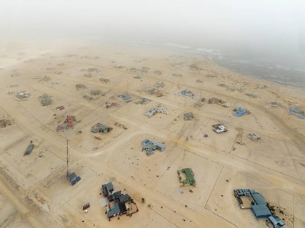 The odd holiday settlement of Wlotzkasbaken at the Atlantic coast often is shrouded in mist. Aerial