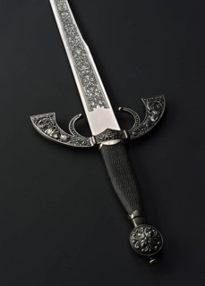 This image features an intricately designed Spanish steel sword with a detailed handle and blade,