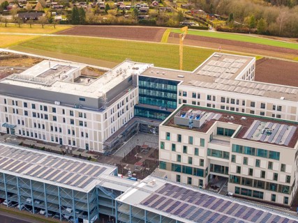 Close-up of a modern office building with solar roof near suburbs, just in front of opening, Calw