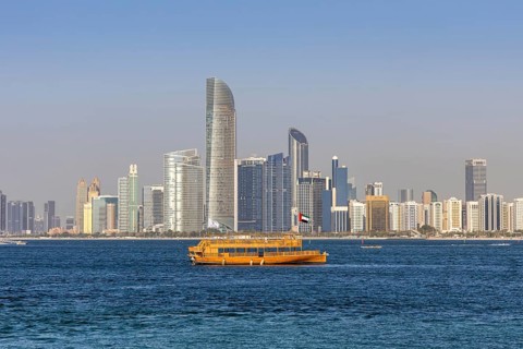 Abu Dhabi skyline skyscrapers by the sea with dhow in Abu Dhabi, United Arab Emirates