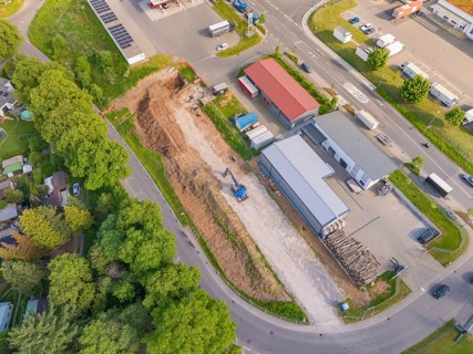Bird's-eye view of construction site with excavator and surrounding buildings, Parkhaus Bau, Calw,