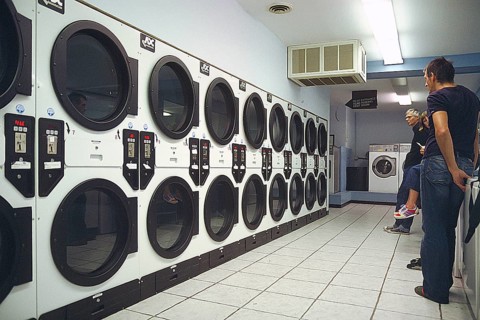 Customers wait for their laundry at a self-service laundromat, Newton, New Jersey, USA