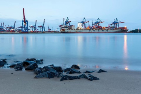 Elbe beach with container terminal and ships in the background in Hamburg