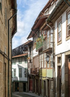 Street of historic buildings with balconies, Rua das Trinas, city centre Guimaraes, northern