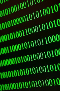 Vertical and diagonal binary numbers in green, conveys IT world