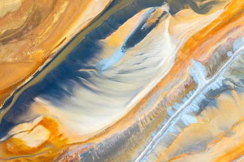 A captivating abstract image featuring flowing textures in vibrant hues of blue, orange, and yellow