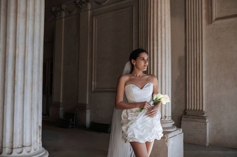 A bride in a white dress stands in an ancient villa in Treia, province of Macerata, Italy. The