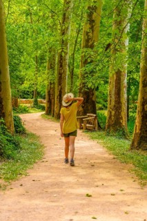 A woman walking through a forest in the Monasterio de Piedra Natural Park, Aragon