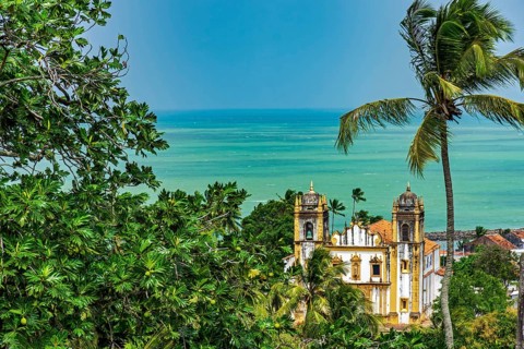 Antique baroque church between vegetation and the sea in the city of Olinda in Pernambuco, Olinda,
